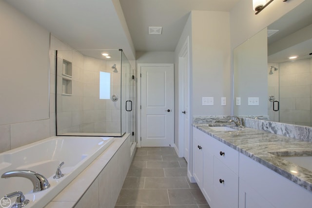 bathroom with tile patterned flooring, vanity, and separate shower and tub