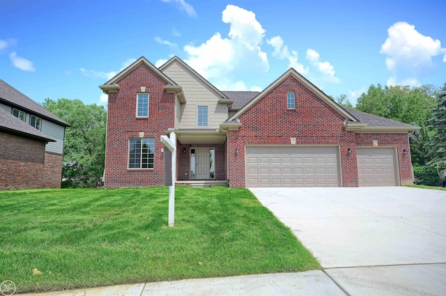 view of front of property featuring a front yard and a garage