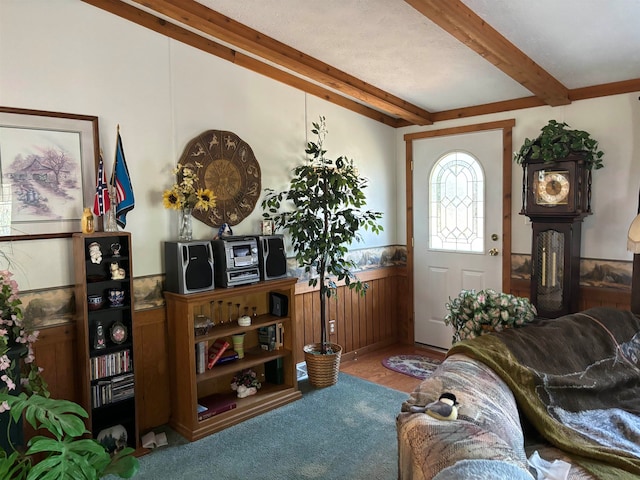 carpeted entrance foyer with beamed ceiling