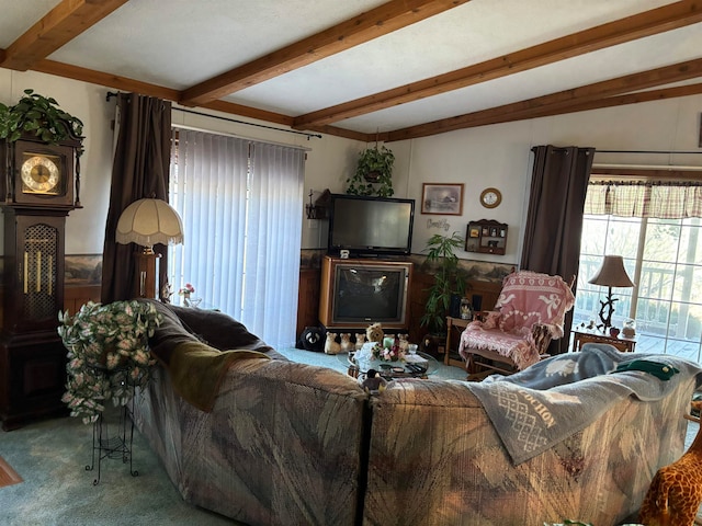 living room with beamed ceiling and carpet floors