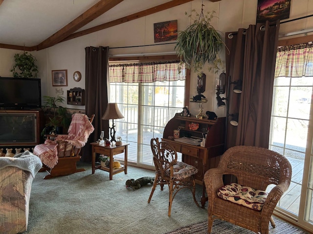 carpeted living room featuring lofted ceiling with beams