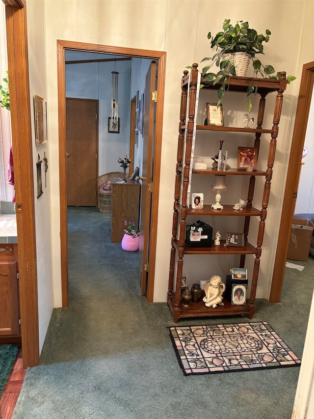 corridor featuring dark colored carpet