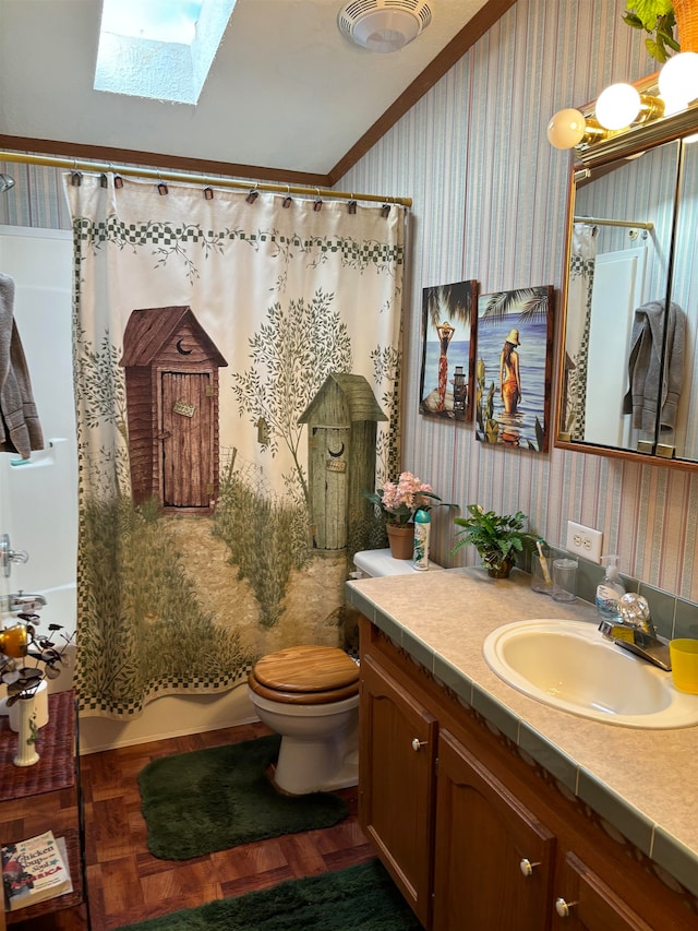 full bathroom featuring toilet, ornamental molding, vanity, shower / bath combo with shower curtain, and vaulted ceiling with skylight