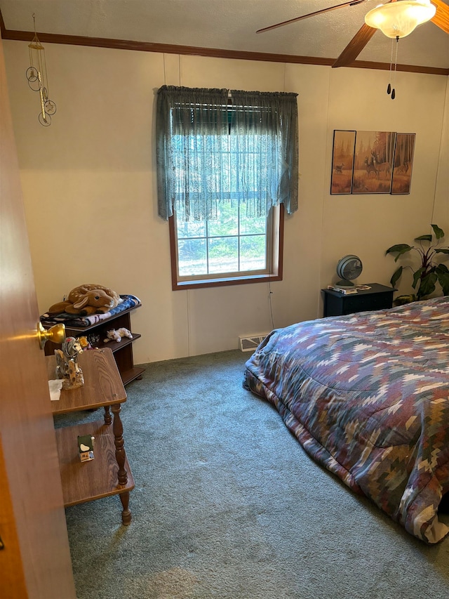 carpeted bedroom featuring ornamental molding and ceiling fan