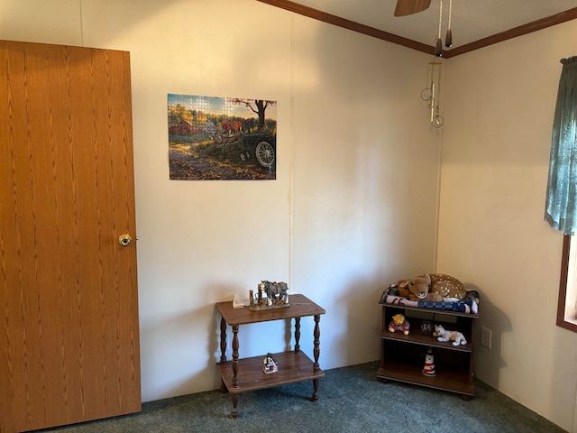 interior space with ornamental molding and ceiling fan