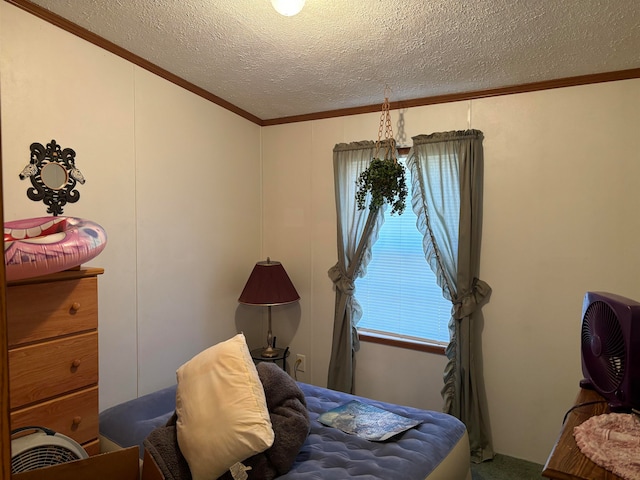 bedroom with ornamental molding and a textured ceiling