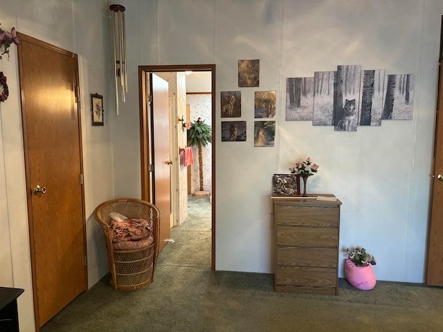 hallway featuring dark colored carpet