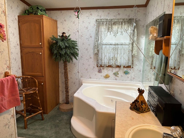 bathroom with a bath, crown molding, and sink