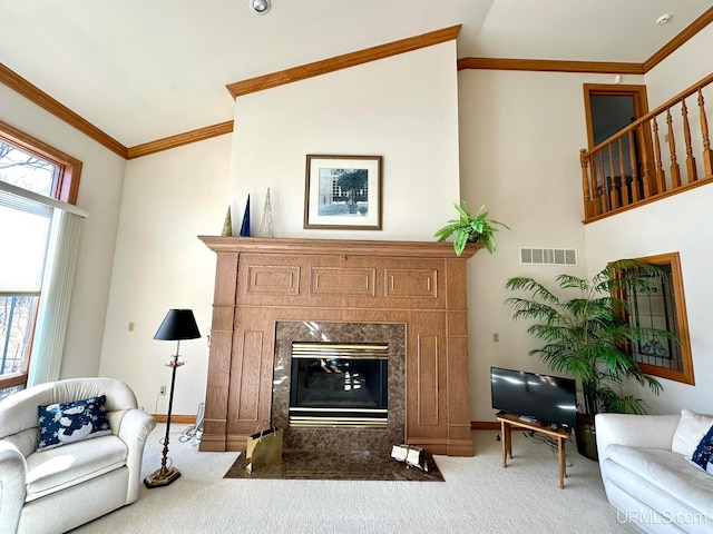 living room with ornamental molding and carpet