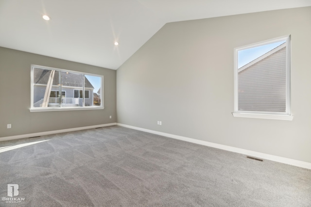 unfurnished room featuring carpet floors and lofted ceiling