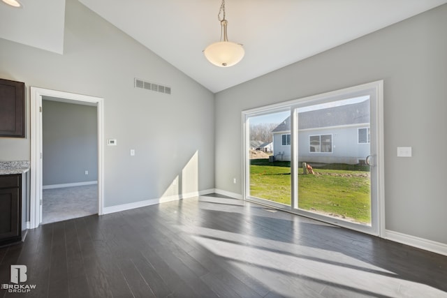 spare room with high vaulted ceiling and dark hardwood / wood-style flooring