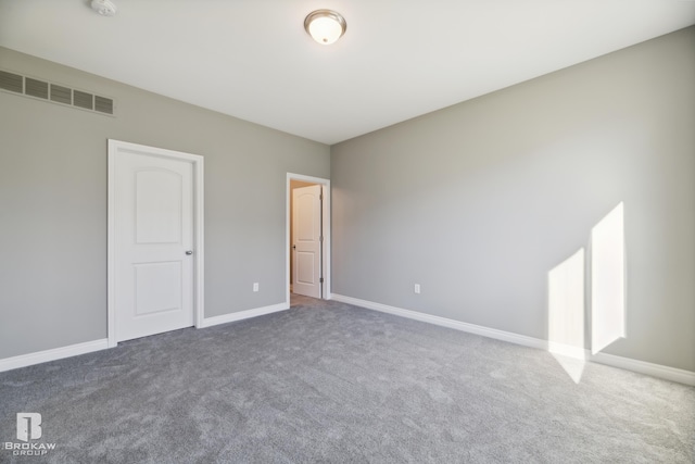 unfurnished bedroom with dark carpet