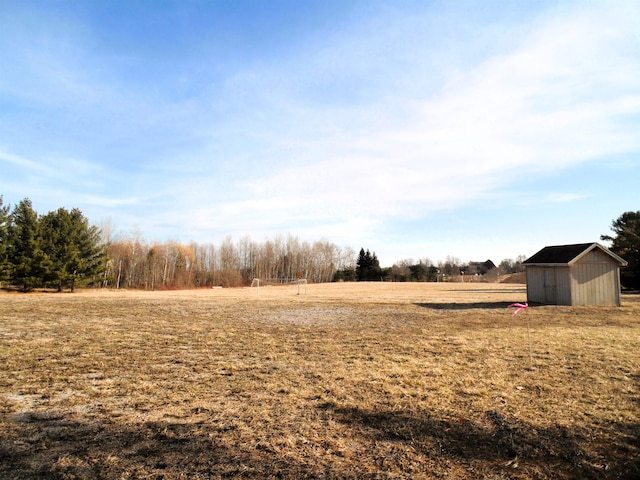 view of yard featuring a storage unit and a rural view