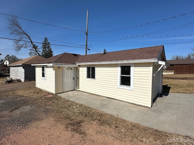 rear view of house with a patio area and an outdoor structure