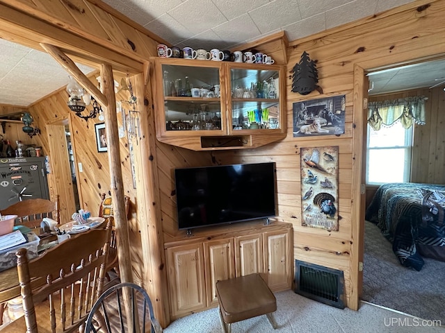 living room with wood walls and light carpet