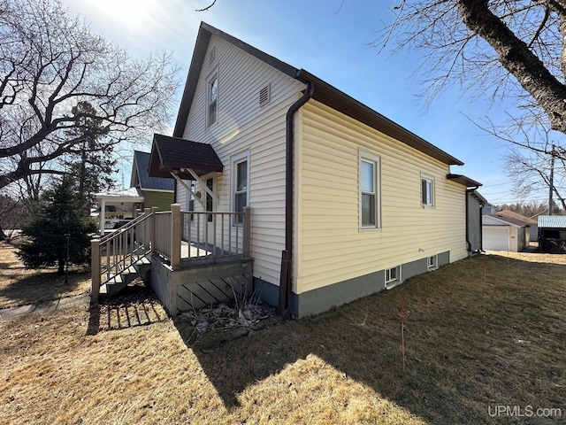 view of home's exterior featuring a lawn and a garage