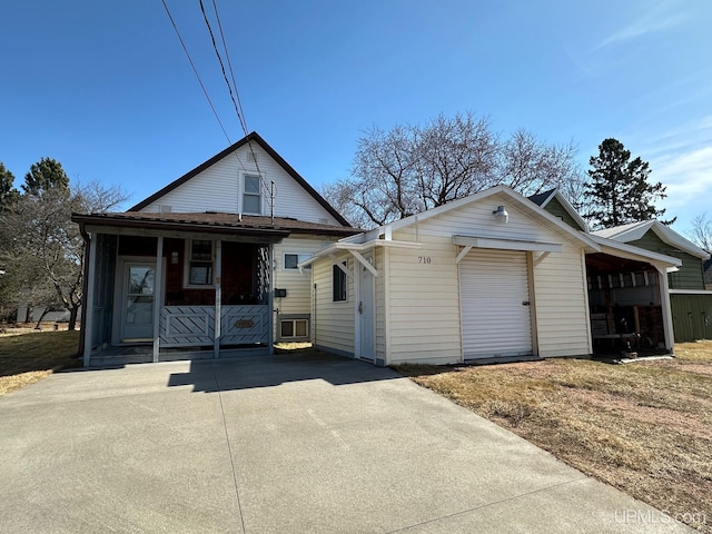 bungalow-style home with a porch and a garage