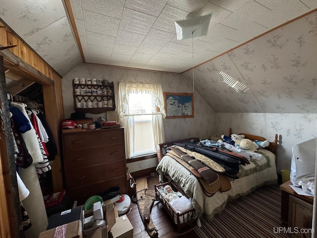 bedroom with lofted ceiling and dark hardwood / wood-style floors