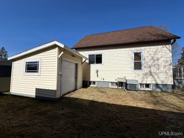 rear view of property featuring a lawn