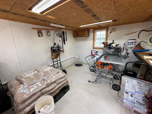 miscellaneous room featuring concrete flooring and a workshop area