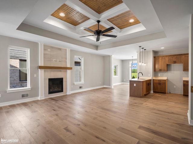 unfurnished room featuring beam ceiling, wooden ceiling, light hardwood / wood-style floors, and ceiling fan with notable chandelier