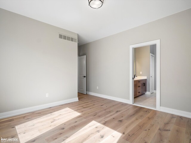 unfurnished bedroom featuring light hardwood / wood-style flooring and a closet