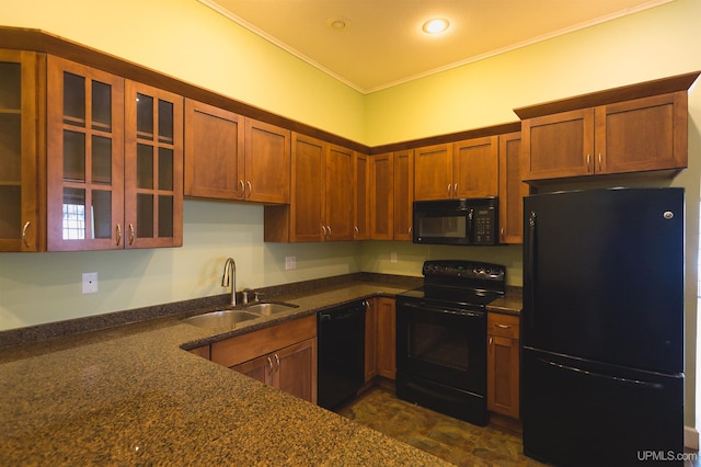 kitchen with black appliances, sink, dark stone countertops, dark tile flooring, and ornamental molding