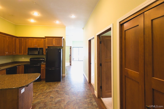 kitchen with dark stone counters and black appliances