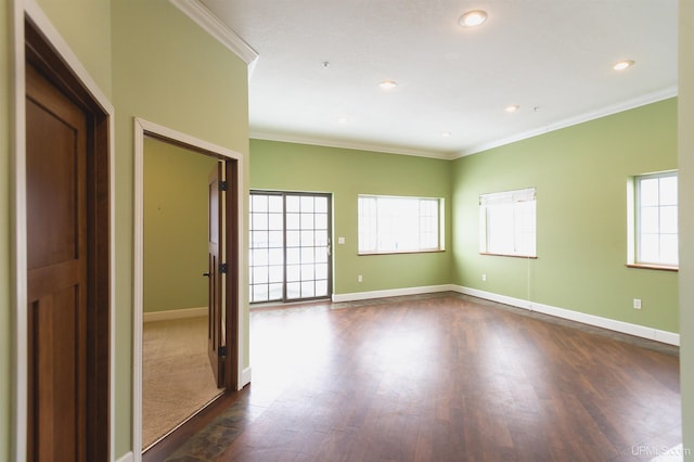 unfurnished room featuring crown molding and dark wood-type flooring