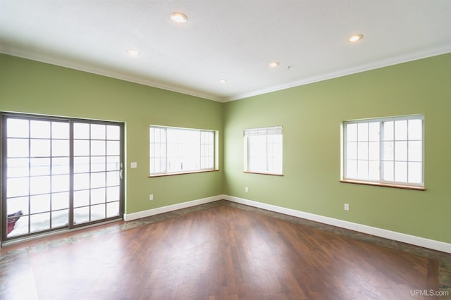 empty room featuring ornamental molding and dark hardwood / wood-style flooring