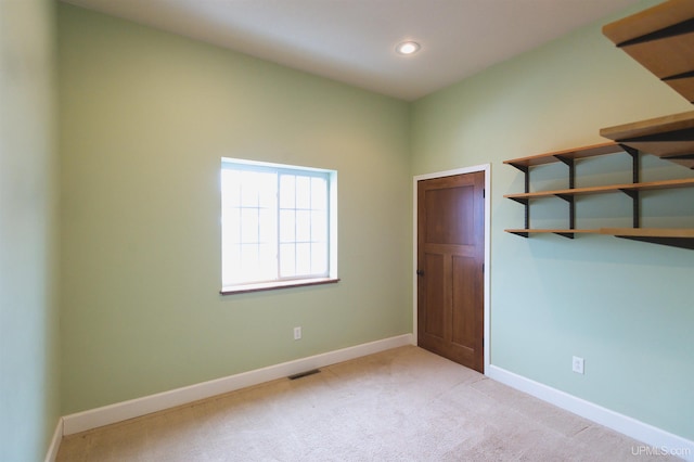 unfurnished bedroom with light colored carpet