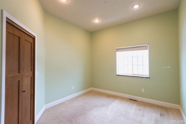 empty room featuring light colored carpet