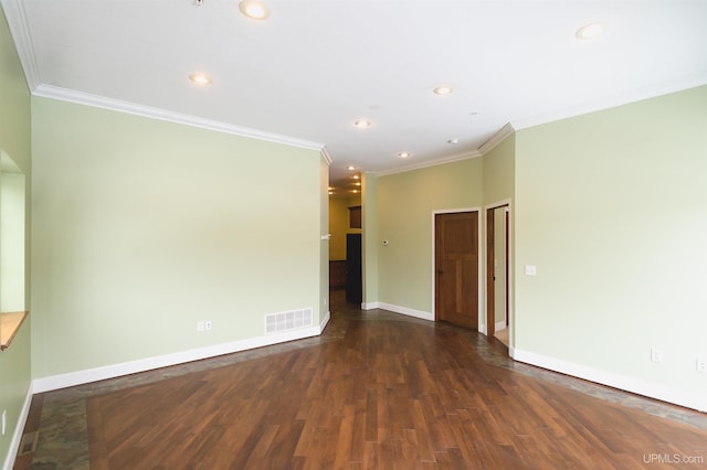 spare room featuring dark hardwood / wood-style flooring and ornamental molding