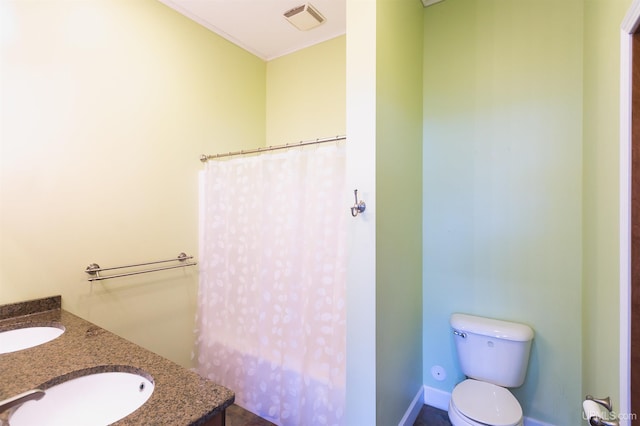 bathroom featuring toilet and vanity