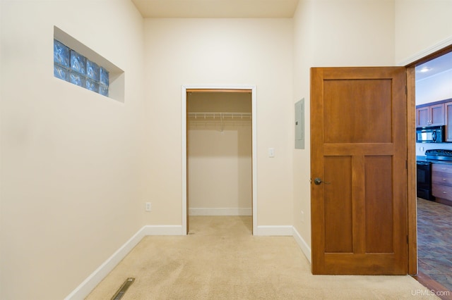 unfurnished bedroom with a closet and light colored carpet