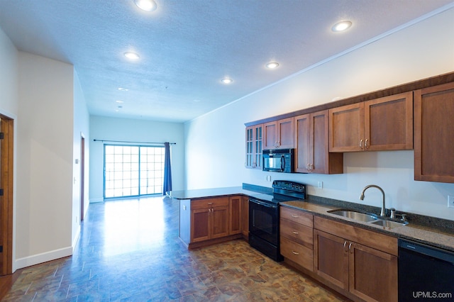 kitchen with dark stone countertops, kitchen peninsula, black appliances, a textured ceiling, and sink