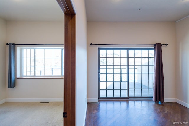 spare room with dark hardwood / wood-style floors