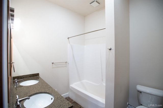 full bathroom featuring toilet, double vanity, tile floors, and bathing tub / shower combination