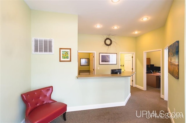 hallway with dark colored carpet