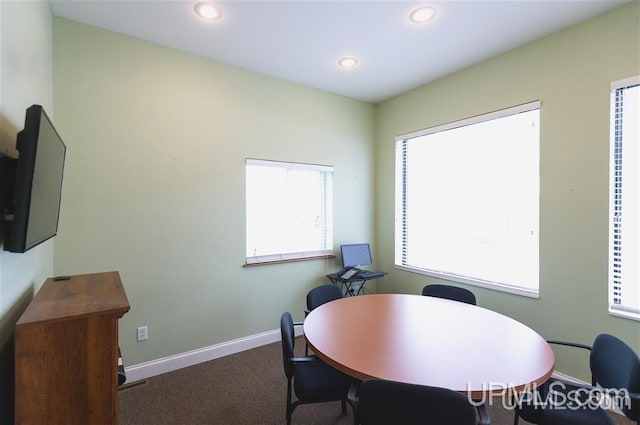 dining area featuring dark carpet