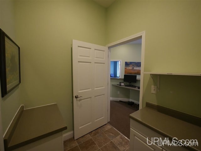 interior space with dark tile floors