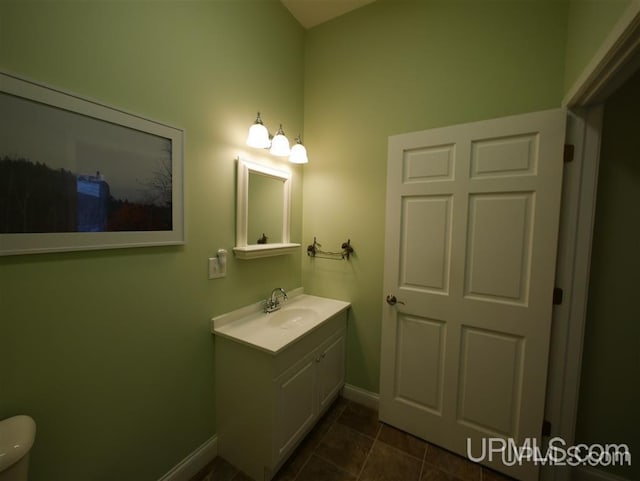 bathroom with tile floors, toilet, and vanity