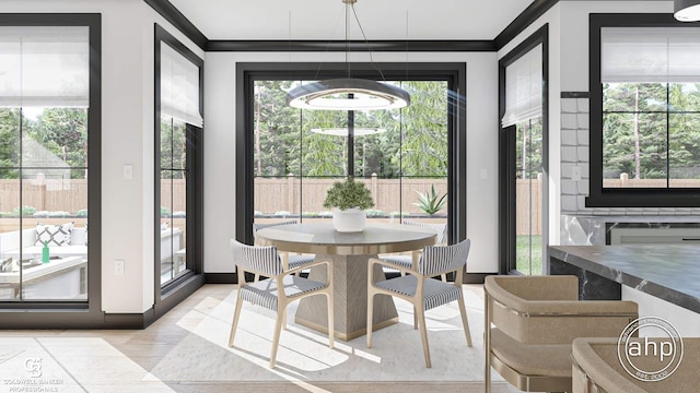 dining space with crown molding and an inviting chandelier