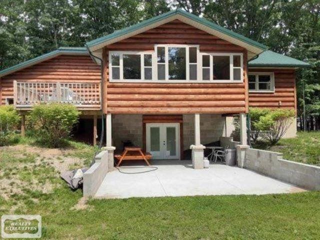 back of house with a patio, french doors, a deck, and a yard