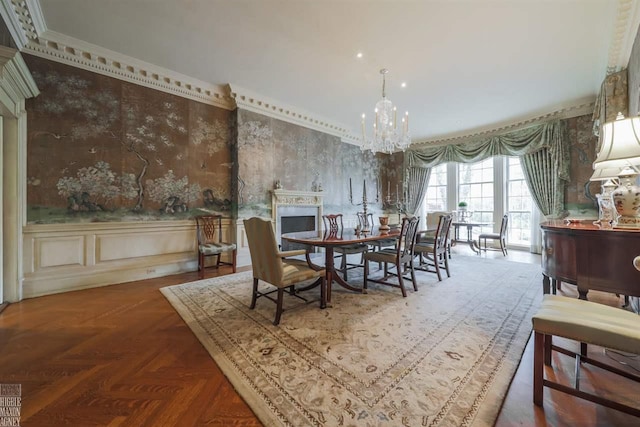 dining room featuring dark parquet flooring, crown molding, and a chandelier