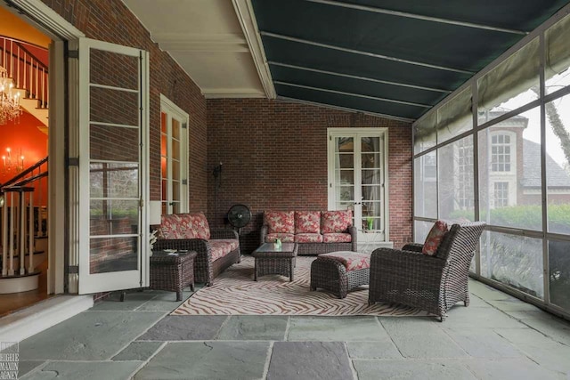 unfurnished sunroom with an inviting chandelier and lofted ceiling