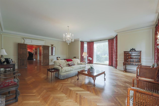 living room featuring light parquet flooring, ornamental molding, and a notable chandelier