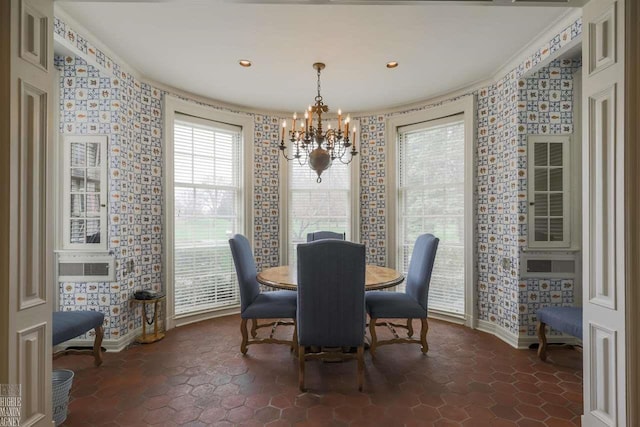 dining area featuring dark tile floors and an inviting chandelier