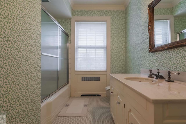 full bathroom featuring tile flooring, vanity with extensive cabinet space, toilet, enclosed tub / shower combo, and ornamental molding