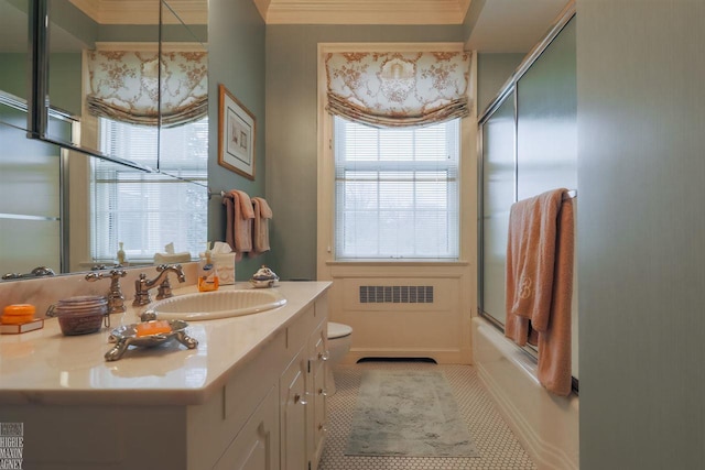 full bathroom with toilet, large vanity, crown molding, tile floors, and bath / shower combo with glass door